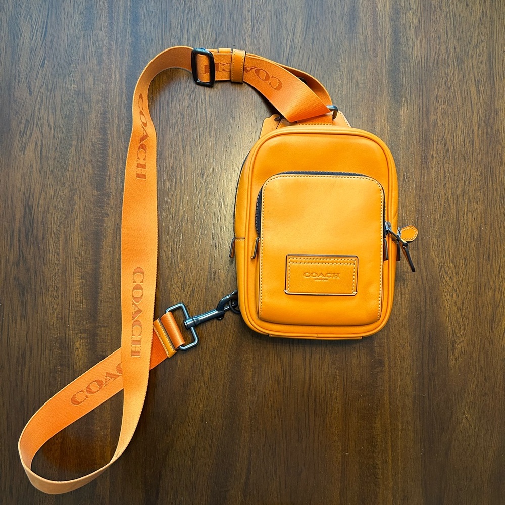 Orange sling crossbody Coach bag